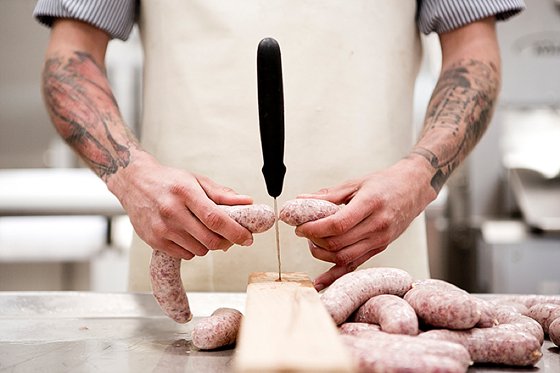 Sausage being cut at Steensgaard Farm, Denmark