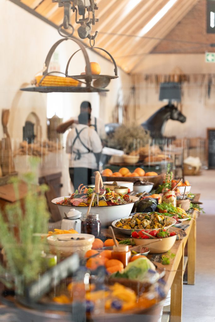 A table laden with farm-fresh fare in the historic Old Stables Restaurant at Soetmelksvlei.